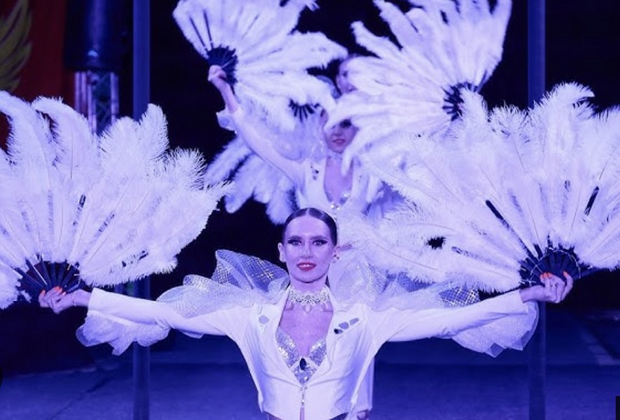 Show dancers performing with feather fans at a PHUKETSOUNDS event in Phuket