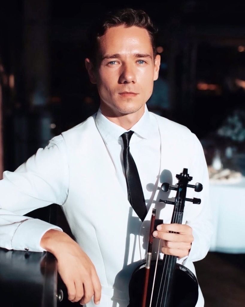Live violinist in a white suit for weddings and villa events in Phuket